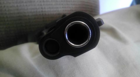 2000 Mercury Grand Marquis - Front view of a pistol barrel, focusing on the muzzle and chamber opening.