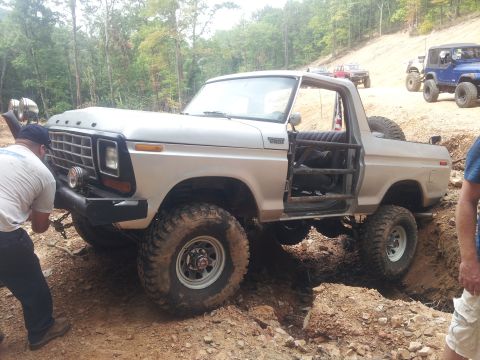 2013 Ford Bronco - Modified 1978 Ford Bronco tackling a challenging off-road course with other vehicles in the background.