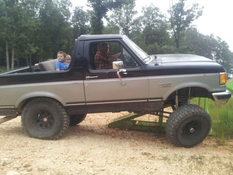 2013 Ford Bronco - This lifted pickup truck appears to be from the early 1990s, not a 2013 model.
