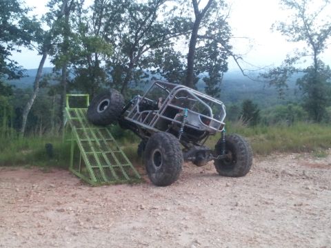 2013 Ford Bronco - Custom off-road buggy with large tires positioned on a green metal ramp.