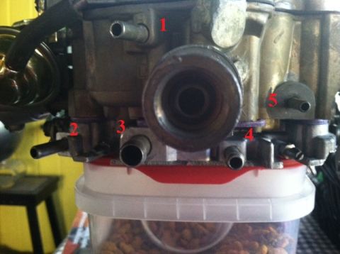 1967 Pontiac Grand Prix - Close-up view of a carburetor, showing various ports and connections.