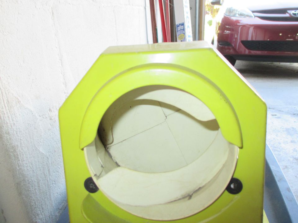 Green plastic housing with a cracked interior, seen from the front