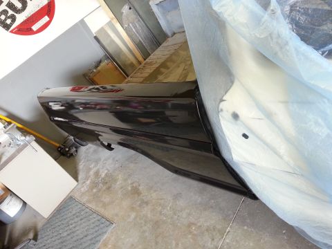 1967 Ford F-100 - A black 1967 Ford F-100 fender and door panel are visible, partially covered by a protective sheet.