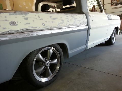 1967 Ford F-100 - This pickup truck is undergoing bodywork, with primer and filler visible on its side panels.