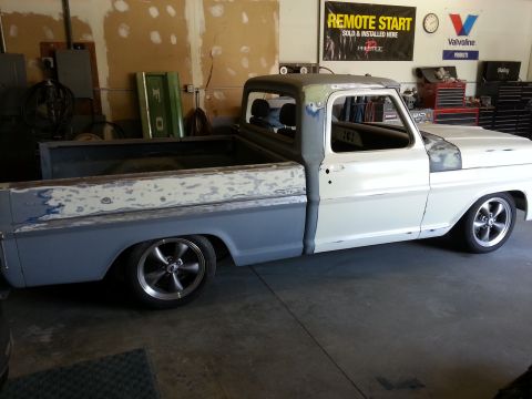 1967 Ford F-100 - This 1967 Ford F-100 truck is in a workshop, showing signs of bodywork and preparation for sale.