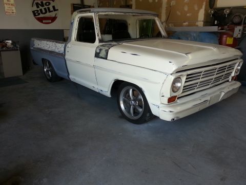 1967 Ford F-100 - This 1967 Ford F-100 pickup truck is shown in a workshop setting, appearing to be in a state of restoration or modification.
