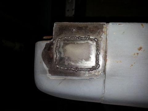 1967 Ford F-100 - Close-up of a repair patch on a vehicle's bodywork, with visible welding marks.
