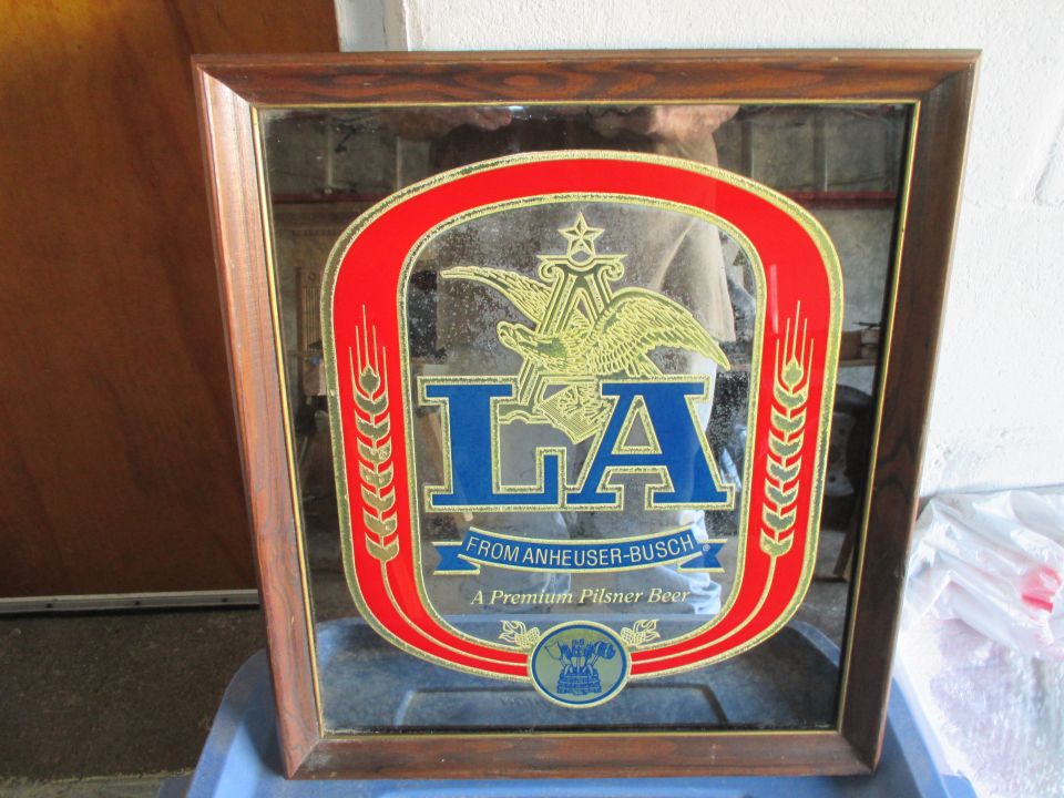 Wooden framed mirror with LA Anheuser-Busch logo and text 'A Premium Pilsner Beer'