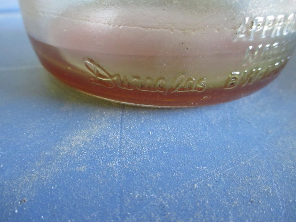 Embossed text on a glass bottle reads "Swan" and "Los Angeles"