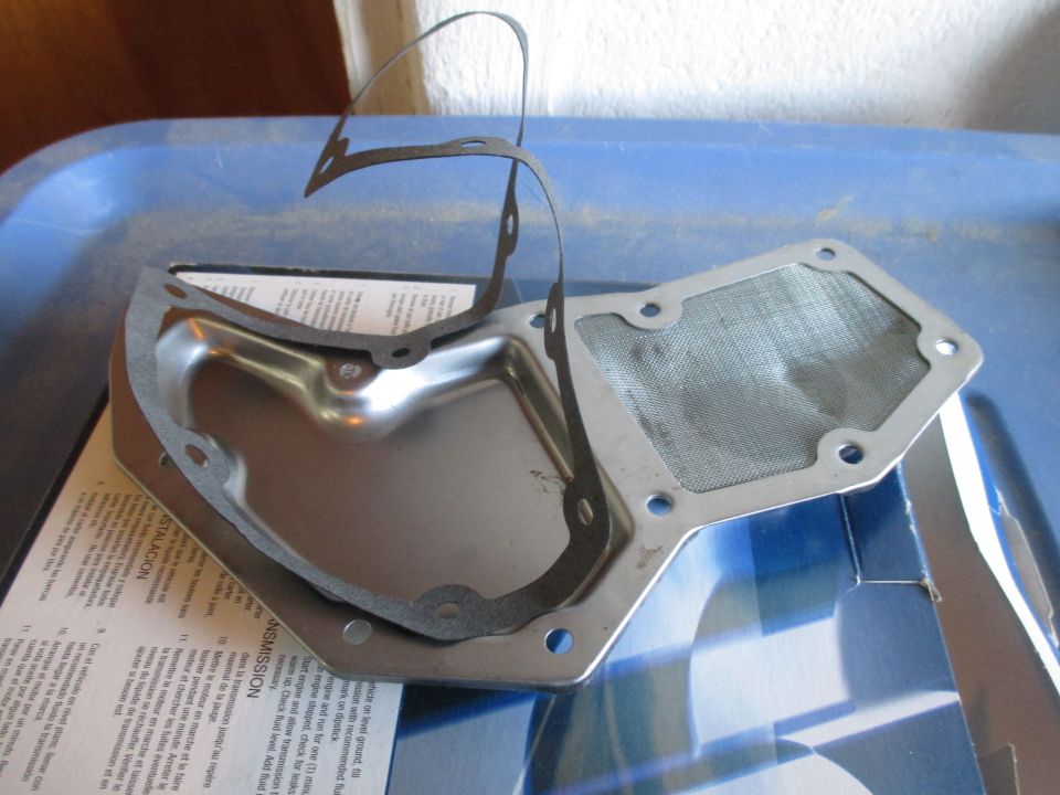 Transmission pan with gasket and filter on top of a document