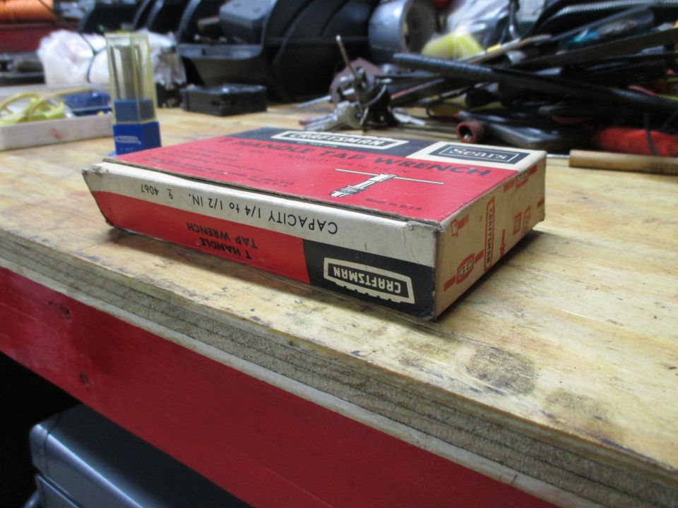 Red and white Craftsman T-Handle Tap Wrench box on a wooden surface