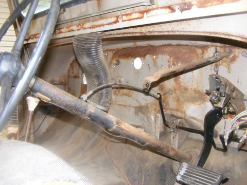1978 Ford Bronco - The interior of a vehicle shows significant rust and wear on its components.
