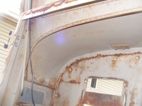 1978 Ford Bronco - The interior of this vehicle shows extensive rust and wear, indicating it is in poor condition.