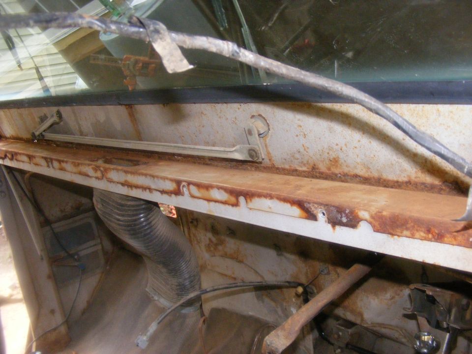 Rusty dashboard interior with visible ducting and wiper mechanism