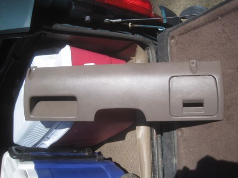 1993 Ford Bronco - A tan dashboard trim panel is shown, likely removed from a vehicle for parts or repair.