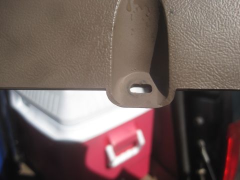 1993 Ford Bronco - A detail shot of the interior trim, showing a mounting point and a cooler in the background.