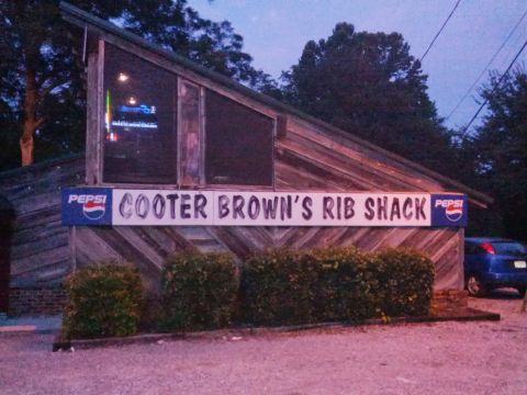 1979 Ford F-150 - A blue car is visible to the right of the Cooter Brown's Rib Shack building.