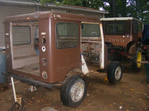 1978 Ford Bronco - This brown Jeep appears to be undergoing restoration or modification, with significant bodywork missing.
