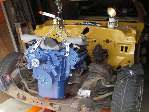 1972 Ford Ranchero - Engine installation in progress on a car chassis, with a CAT mug nearby.