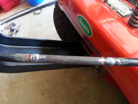 1995 Ford Bronco - Close-up of a mower part, showing repair work and wear.