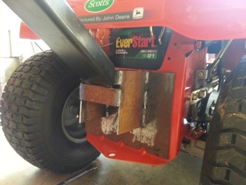 1995 Ford Bronco - Custom metalwork attached to a red lawn mower frame near the wheel.