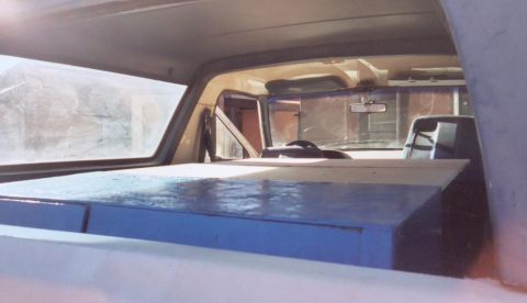 1987 Ford Bronco - throw the tire on the ground fold out a couple peices of wood and i have a 6ftx4ft place to sleep.