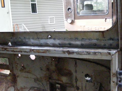 1978 Ford Bronco - The interior of a vehicle chassis shows extensive rust and visible spot welds, indicating a project in progress.
