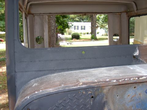 1978 Ford Bronco - Interior of a vintage vehicle, showing the rear cargo area and a view through the window.