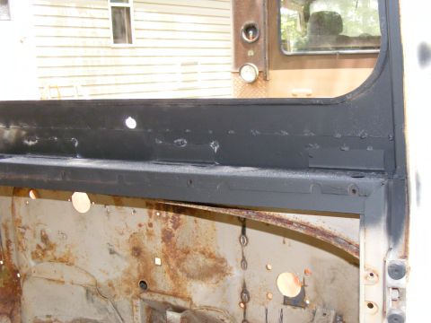 1978 Ford Bronco - Interior view of a vehicle's door frame showing rust and metalwork.