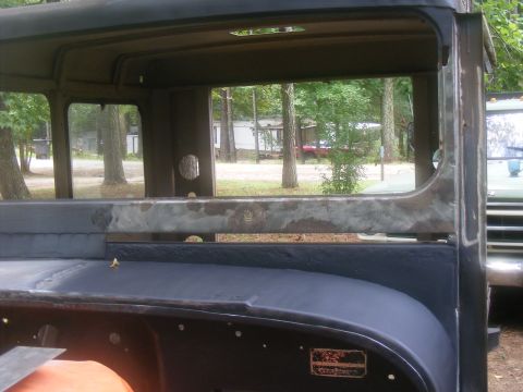 1978 Ford Bronco - The interior of a vintage truck cab is shown, with a glimpse of another vehicle in the background.