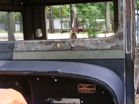 1978 Ford Bronco - Interior view of a vintage truck, showing some rust and a clamp on the window frame.