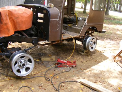 1978 Ford Bronco - A vehicle undergoing repairs, with its wheels off and chassis elevated on blocks.