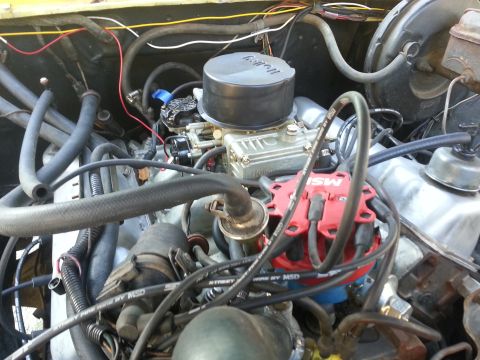 1978 Ford Bronco - Close-up view of an engine bay, focusing on the carburetor and distributor components.