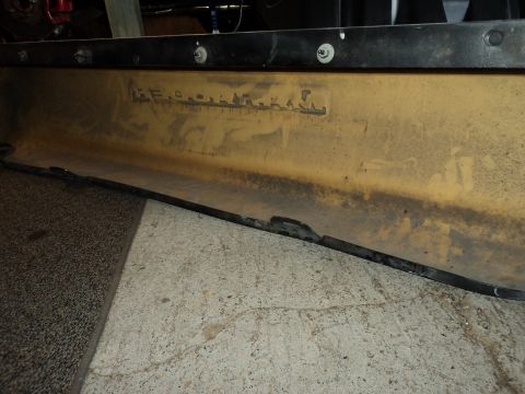 2004 Mercury Grand Marquis - A close-up of a yellowed automotive part shows embossed lettering, but the vehicle year and model are not identifiable.