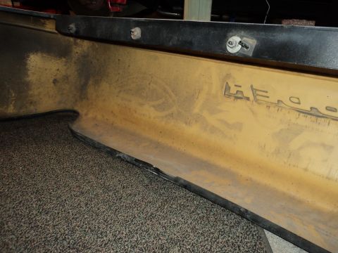 2004 Mercury Grand Marquis - The interior of a yellow bumper shows embossed text reading 'AERO'.