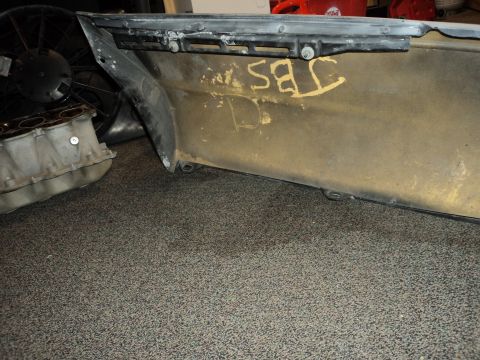 2004 Mercury Grand Marquis - Close-up of a car bumper and engine components on a carpeted floor.