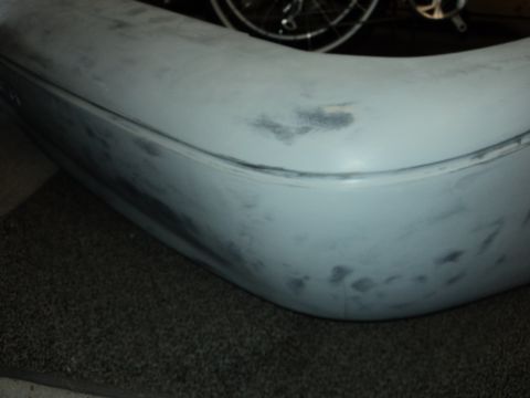 2004 Mercury Grand Marquis - Car bumper covered in primer, showing signs of preparation for paint.