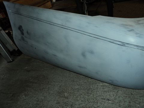 2004 Mercury Grand Marquis - A gray fender, likely prepped for paint, shows a subtle double body line detail.