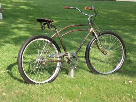 1994 Ford Bronco - A vintage-style bicycle with a brown frame and chrome accents sits on a grassy lawn.
