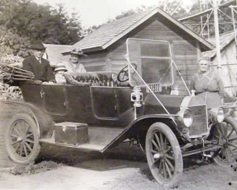 1912 Ford Model T - A family poses with their 1912 Ford Model T, which features a touring body style and a license plate reading '37977'.