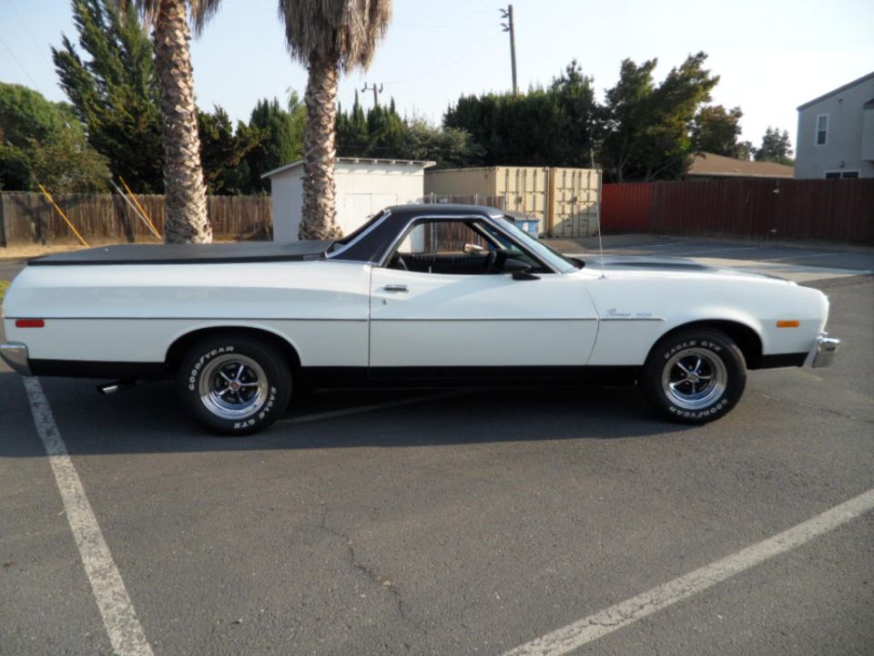White 1973 Ford Ranchero side view with black bed cover and racing stripes