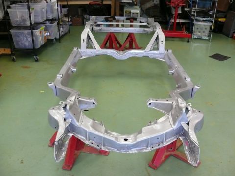 1976 Chevrolet Corvette - A bare car frame is displayed in a workshop setting, awaiting restoration or assembly.