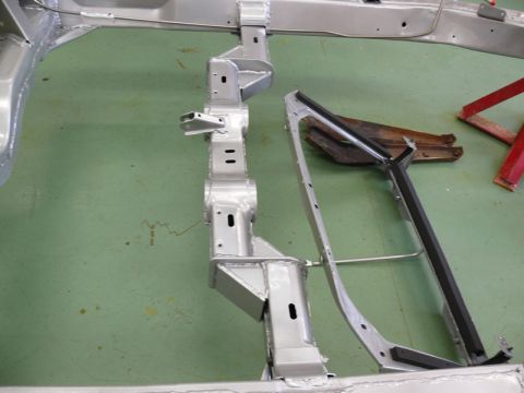 1976 Chevrolet Corvette - Close-up of a vehicle's chassis components, showing structural metalwork and support elements.
