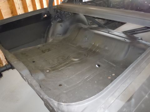 2001 Ford Crown Victoria - Interior floor pan of a vehicle undergoing restoration, showing stamped metal details.