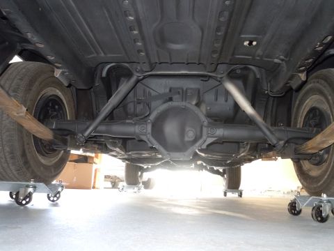 2001 Ford Crown Victoria - The undercarriage of a vehicle is shown, supported by dollies for mobility.