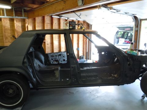 2001 Ford Crown Victoria - This vehicle appears to be undergoing a significant restoration or modification, with its interior completely gutted and doors removed.