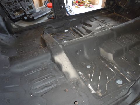 2001 Ford Crown Victoria - The bare floor pan of a car interior, stripped down for restoration or modification.