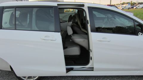 2012 Mazda Mazda 5 - Interior view of a white minivan with sliding doors open, revealing the grey seating arrangement.