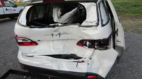 2012 Mazda Mazda 5 - This 2012 Mazda Mazda 5 sustained significant rear-end collision damage, affecting the tailgate, taillights, and rear window.