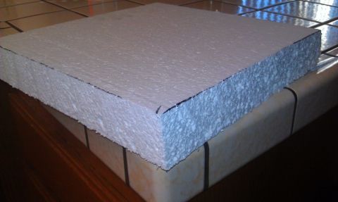 1989 Ford Bronco - A white styrofoam block with a blue line along its edge sits on a surface with tiles and wood.